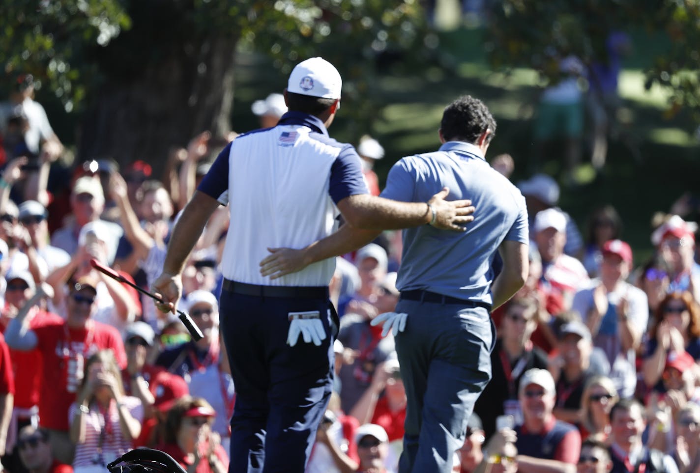 USA golfer, Patrick Reed and European, Rory McIlroy, show respect to each other as they matched birdies during the Sunday morning match play.