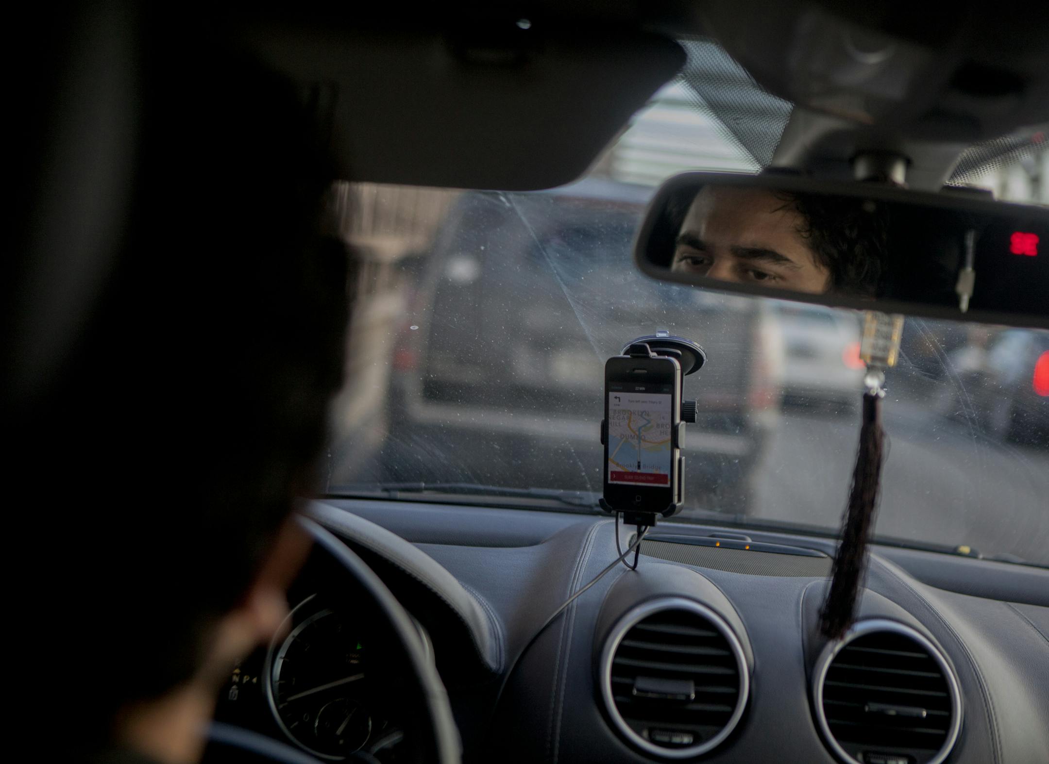 FILE-- An Uber driver drives on the Brooklyn Bridge in New York, Jan. 30, 2015. Uber has announced a host of software improvements to its app to address driver demands. Among the changes, drivers can now more easily pause ride requests, making it easier for them to take bathroom breaks and fill their gas tanks. They can also be paid instantly for each ride they complete, rather than weekly, and see on the app&#x2019;s dashboard how much they have earned. (Sam Hodgson/The New York Times)