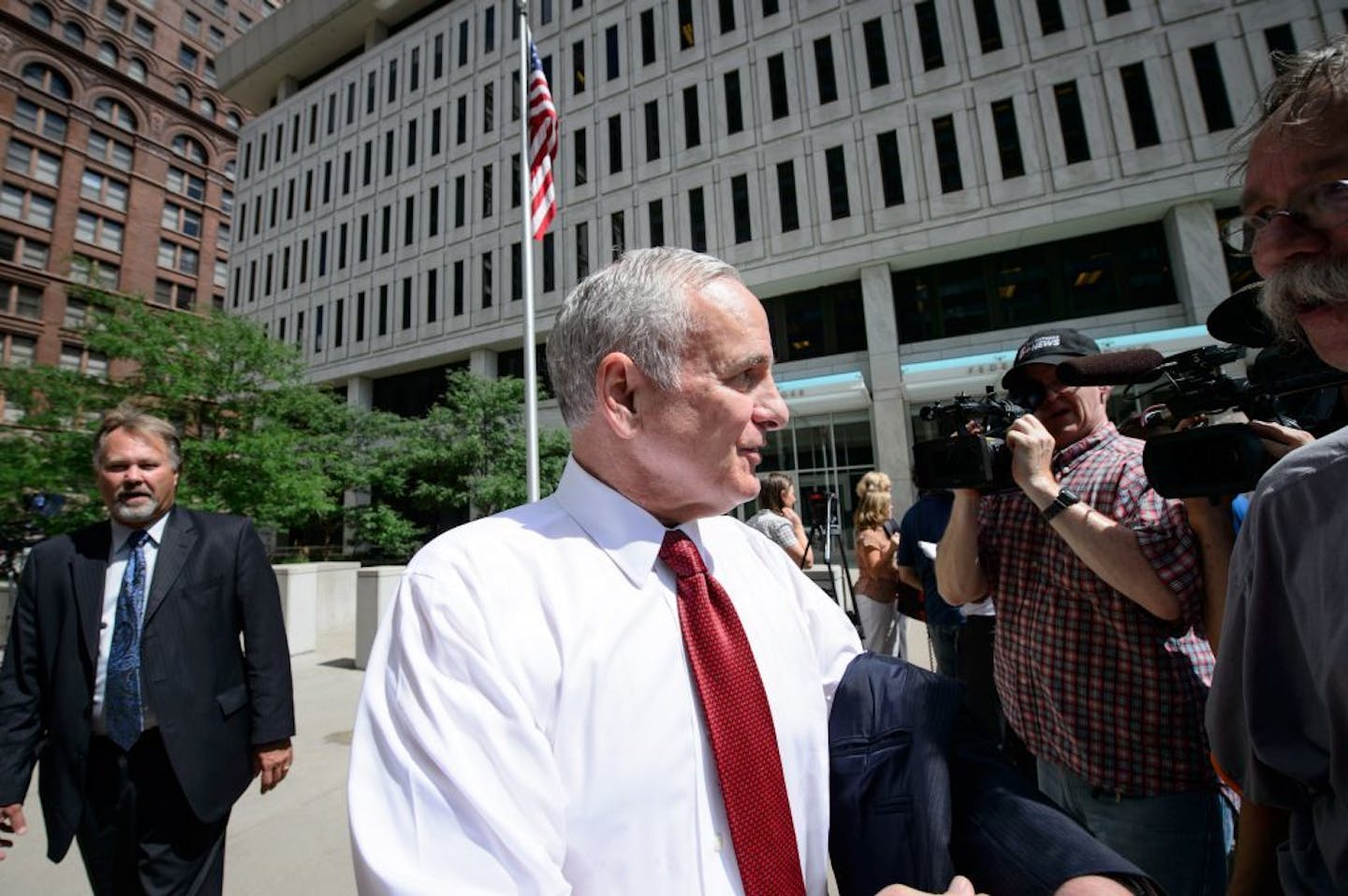 Gov. Mark Dayton talked with reporters as he left the meeting at the Federal Courthouse in St. Paul, MN.