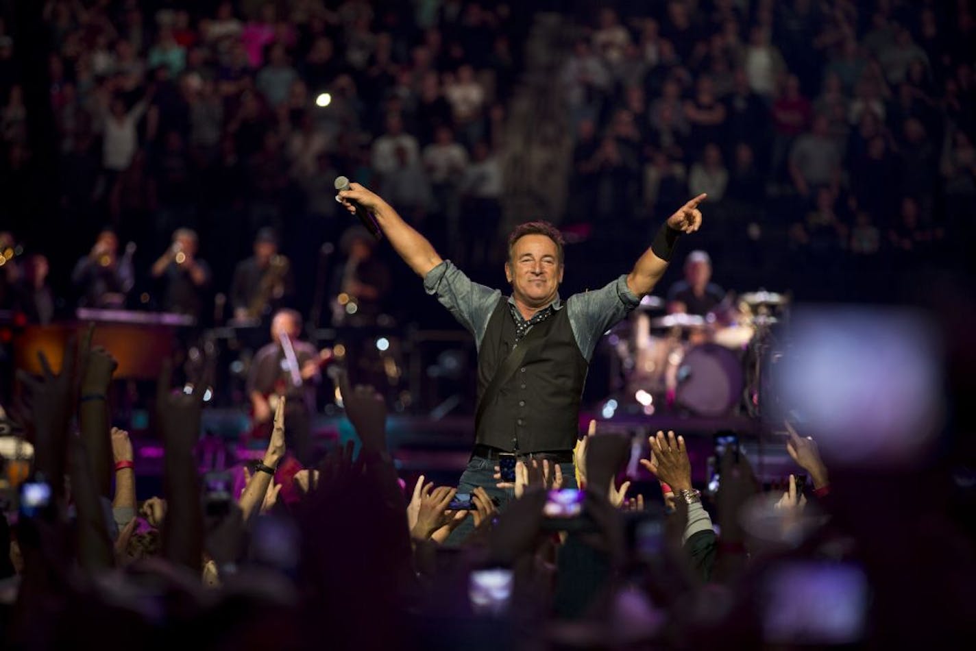 Bruce Springsteen directed the crowd from a platform Sunday at the Xcel Energy Center.