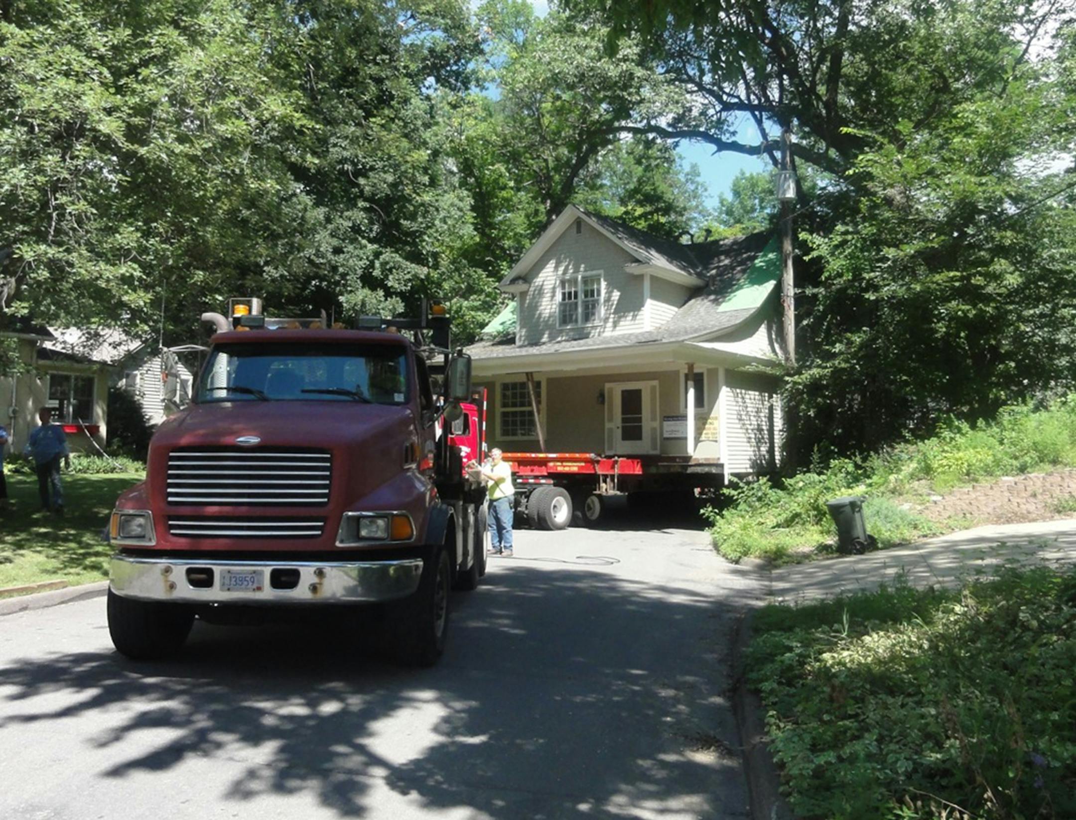 Crews move the historic Wise House in Wayzata down the street on Aug. 10, 2015 to prepare for its move about a mile away. It will be repurposed as a conference center, making room for a housing subdivision on the land where it stood for 111 years. Submitted photo by Joel Papa.