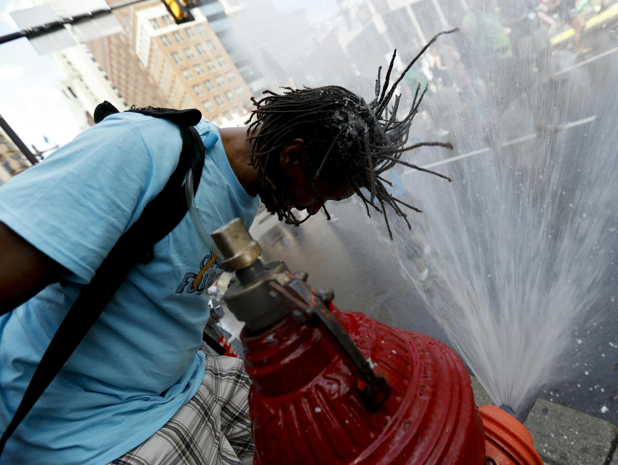 A supporter of Sen. Bernie Sanders, I-Vt., cools off during a march in downtown on Sunday, July 24, 2016, in Philadelphia. The Democratic National Convention starts Monday in Philadelphia. (AP Photo/Alex Brandon)