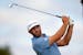 Dustin Johnson tees off on the fourth hole during the first round of the 3M Open