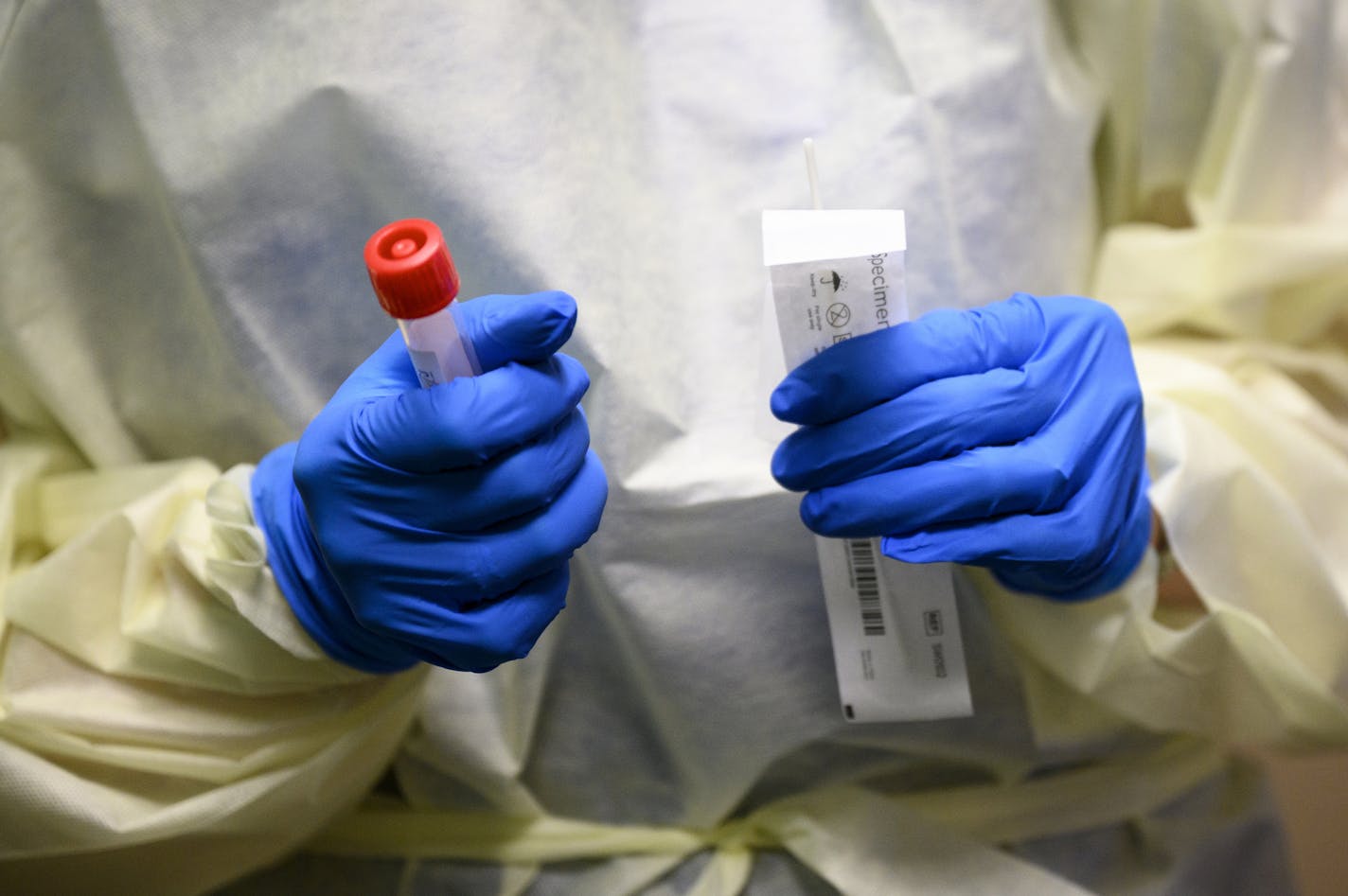 Angie Stransky, a nurse administrator for Mayo Clinic Health System, held a COVID-19 test before administering it a Minnesota State hockey player in Mankato on Oct. 20.