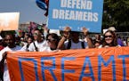 Protesters hold up signs during a rally supporting Deferred Action for Childhood Arrivals, or DACA, outside the White House on September 5, 2017. Thou