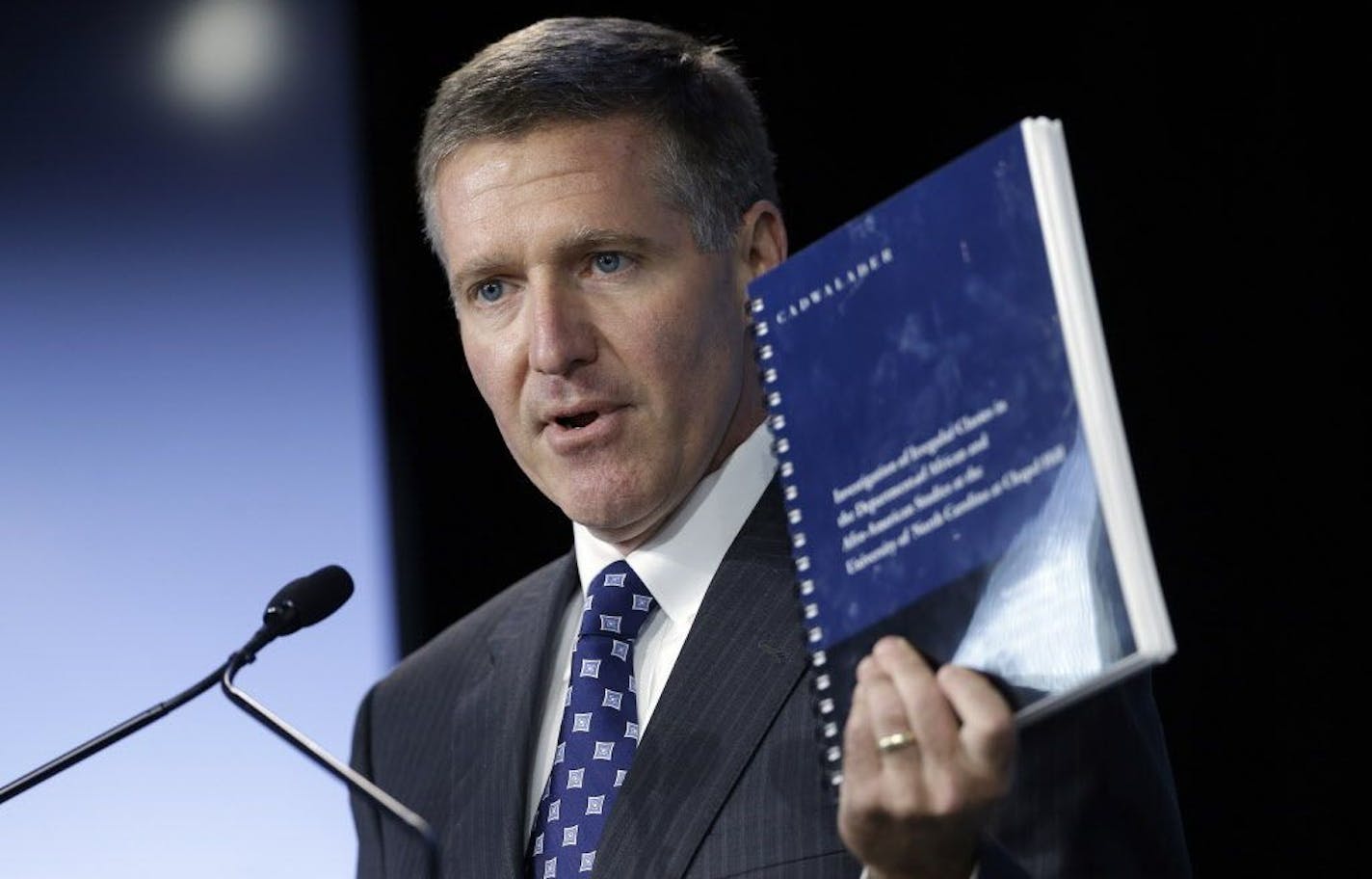 Kenneth Wainstein, lead investigator into academic irregularities at the University of North Carolina at Chapel Hill, holds a copy of his findings.