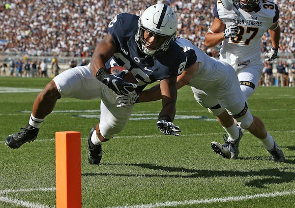 Penn State's Saquon Barkley (26) goes in for a touchdown against Kent State during the first half of an NCAA college football game in State College, P