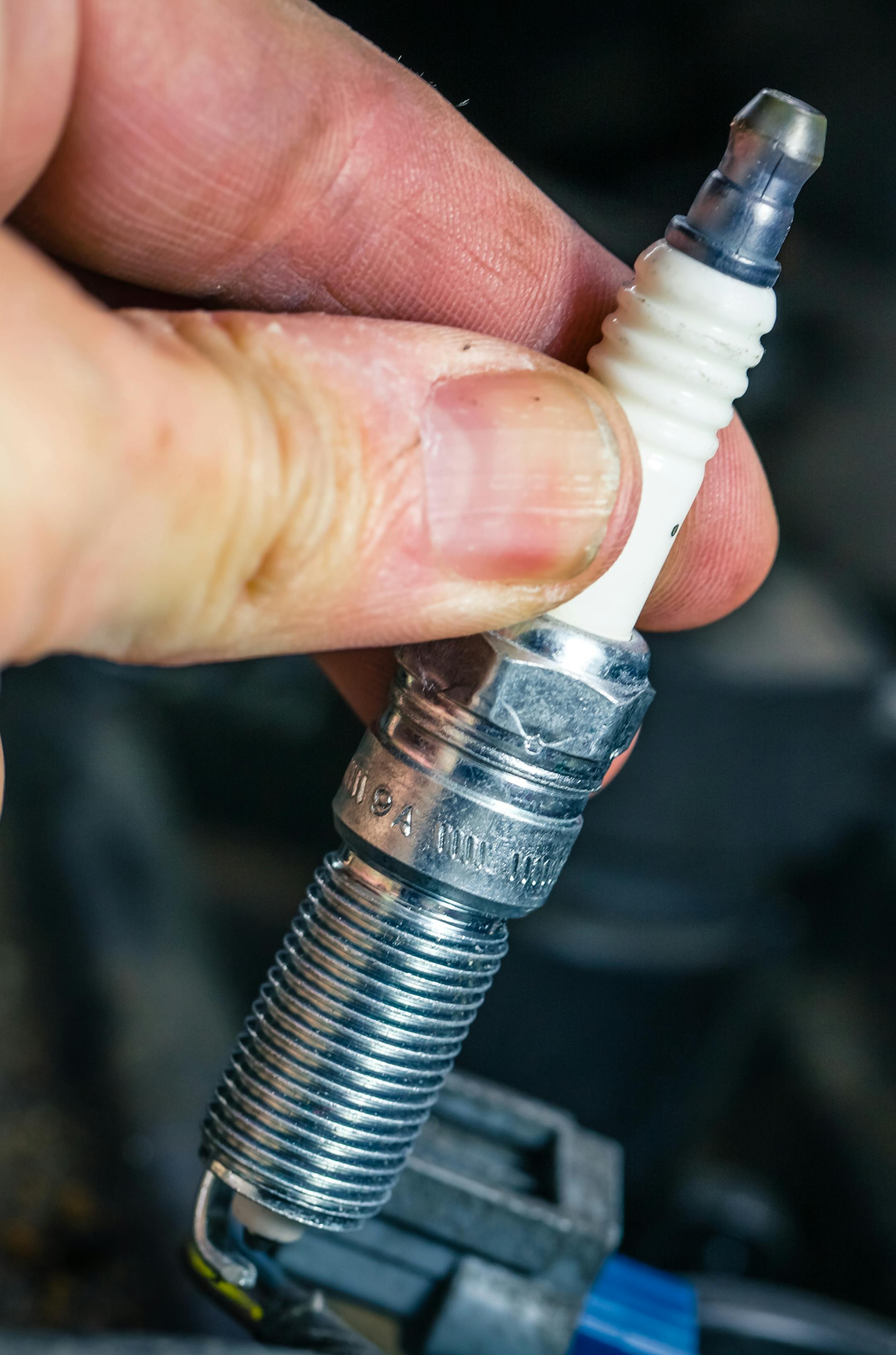Holding spark plug on engine