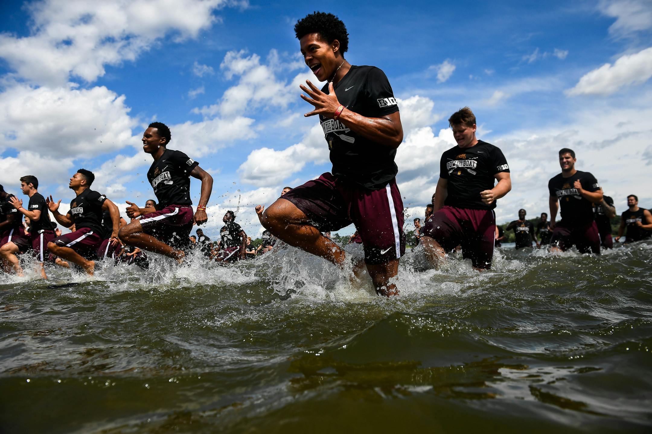 Gophers wide receiver Demetrius Douglas, center, and fellow teammates ran in shallows of Lake Nokomis during practice Friday afternoon. ] AARON LAVINSKY ï aaron.lavinsky@startribune.com The University of Minnesota football team practiced on a beach on Lake Nokomis on Friday, June 23, 2017 in Minneapolis, Minn.