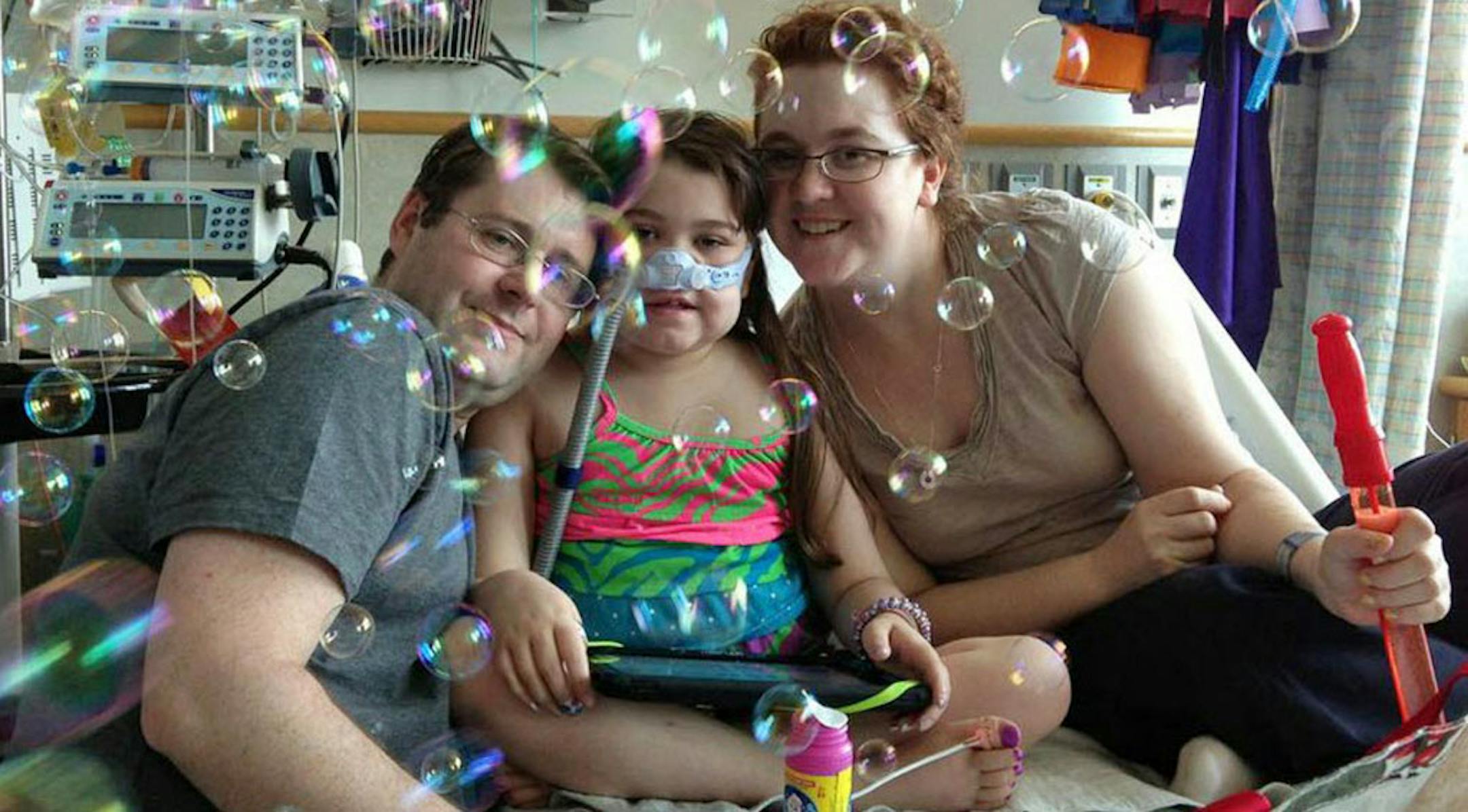 May 30, 2013: Sarah Murnaghan, center, celebrates the 100th day of her stay in Children's Hospital of Philadelphia with her father, Fran, left, and mother, Janet.