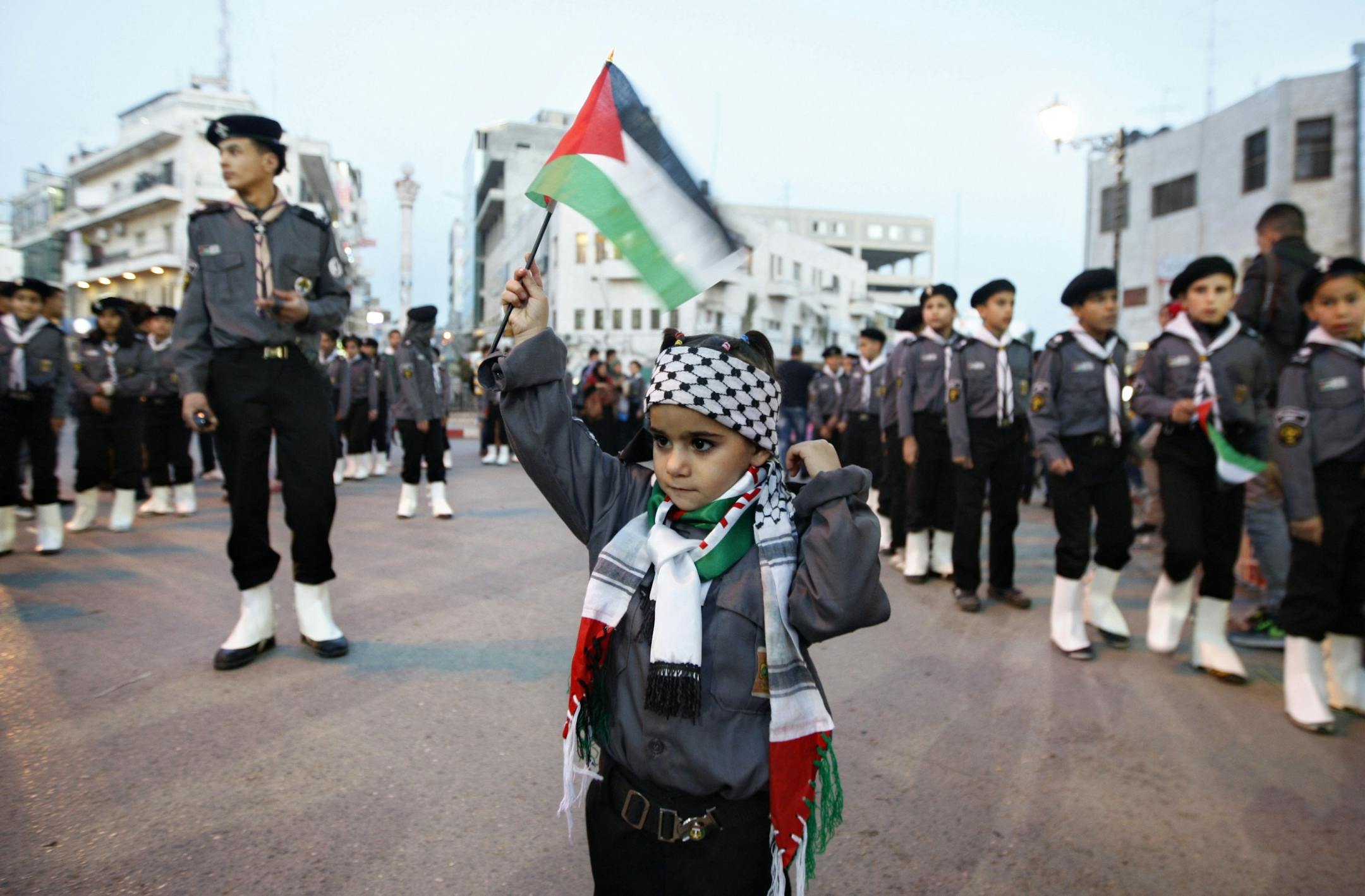 A Palestinian girl waves a flag during a rally supporting the Palestinian U.N. bid for observer state status, in the West bank city of Ramallah.