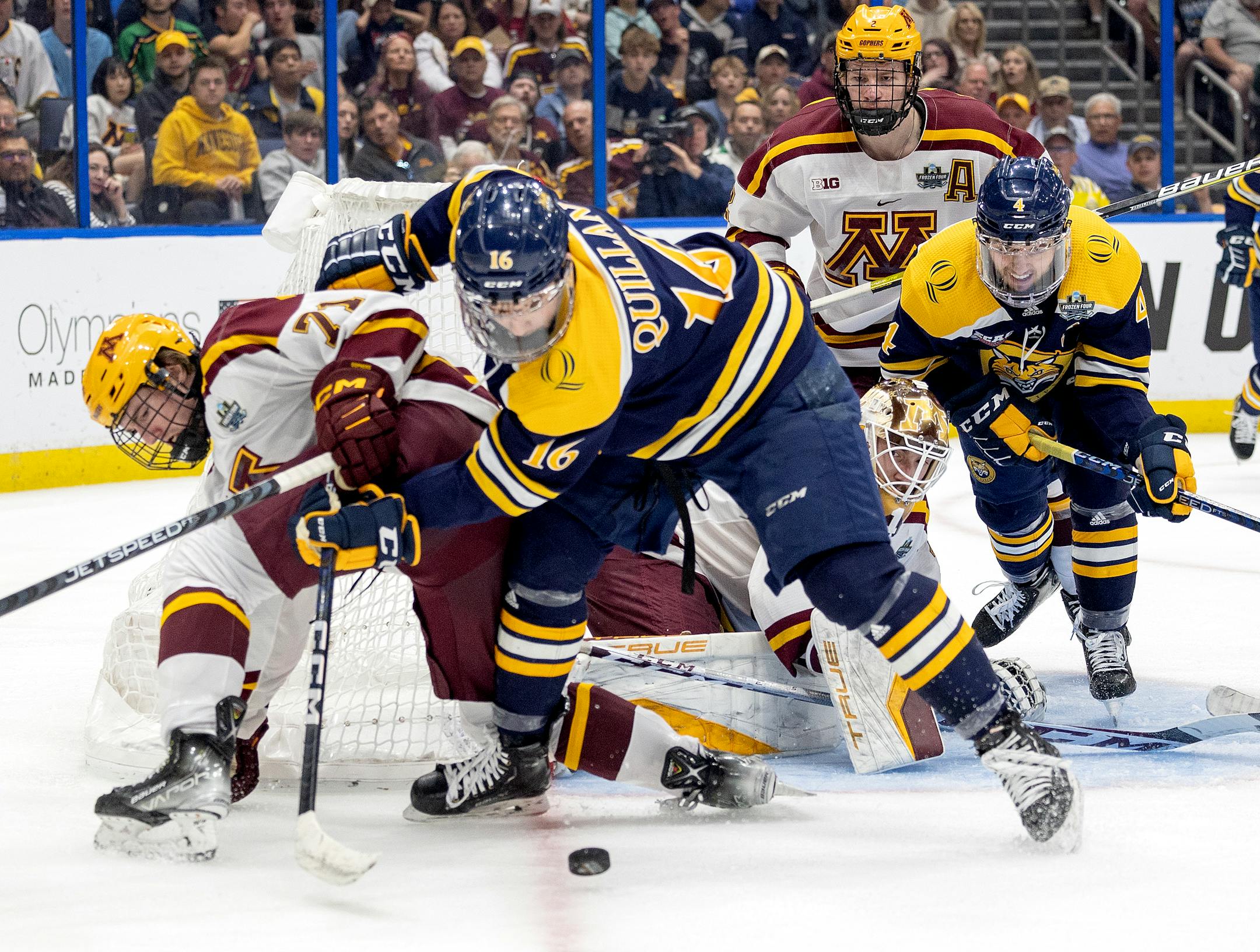 ,Ryan Chesley (71) of Minnesota and Jacob Quillan (16) of Quinnipiac in the second period.