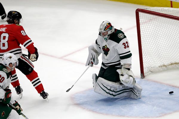 Minnesota Wild goalie Alex Stalock, right, cannot save a shot by Chicago Blackhawks right wing Patrick Kane during the second period of an NHL hockey 