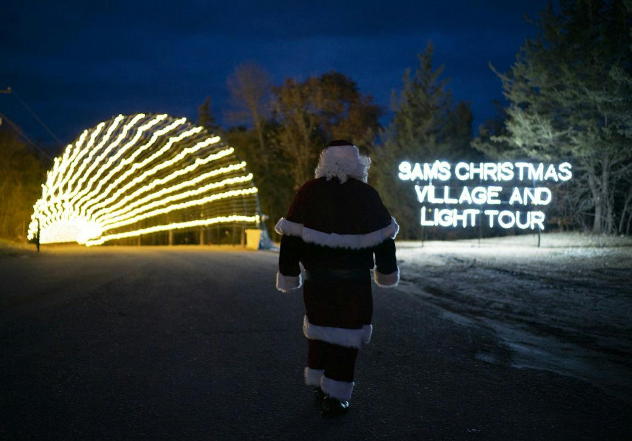 Santa, as portrayed by Lloyd Larrieu, approached the 540 foot long entrance tunnel lit with 220,000 lights.