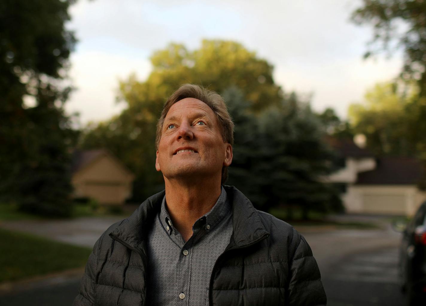 Ted Gladhill spends a fair amount of his time looking up into the skies above his home where planes from MSP taking off on the south runway often fly overhead making a rumbling noise. Gladhill took a moment for a portrait Thursday, Oct. 3, 2019, in Eagan, MN. "It's that long term exposure that irritates us," said Gladhill, who sometimes uses a device to measure ambient noise where he has measured as high as 85 decibels outside his home. A typical rock concert measures between 100 and 120 decibel