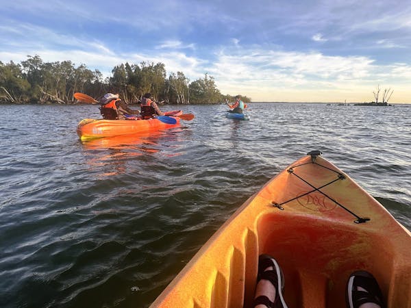 A tour group with BK Adventures heads out on a sunset paddle and night tour in search of bioluminescence at Merritt Island National Wildlife Refuge in