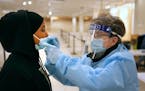 Naima Ahmed received one of the last COVID-19 tests administered by nurse Sue Clarke at the state’s St. Paul Midway testing site before it shut down