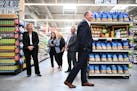 Hy-Vee CEO Randy Edeker, right of center, laughed with a group of corporate employees during a walk-through of the soon-to-be opened Spring Lake Park 
