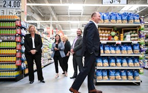 Hy-Vee CEO Randy Edeker, right of center, laughed with a group of corporate employees during a walk-through of the soon-to-be opened Spring Lake Park