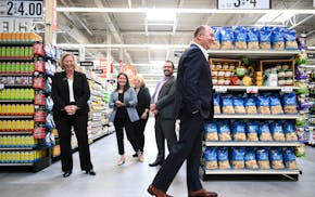 Hy-Vee CEO Randy Edeker, right of center, laughed with a group of corporate employees during a walk-through of the soon-to-be opened Spring Lake Park 