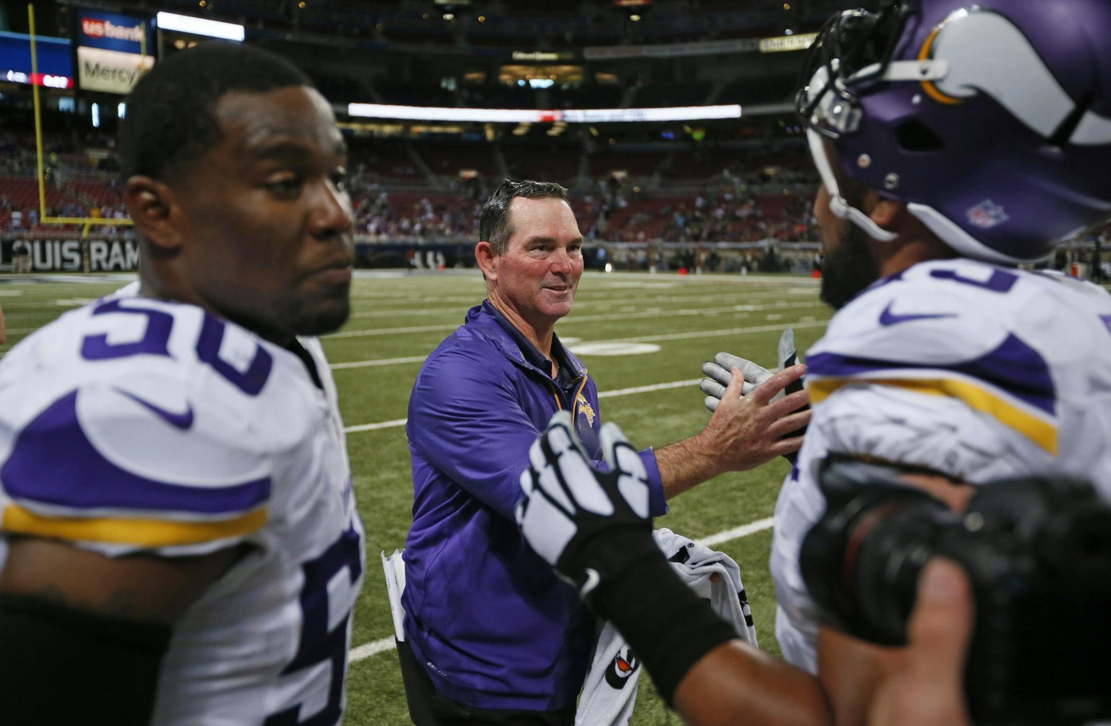 Vikings coach Mike Zimmer gets handshakes from his players after the Vikings 34-6 victory over the St. Louis Rams Sunday in St. Louis.
