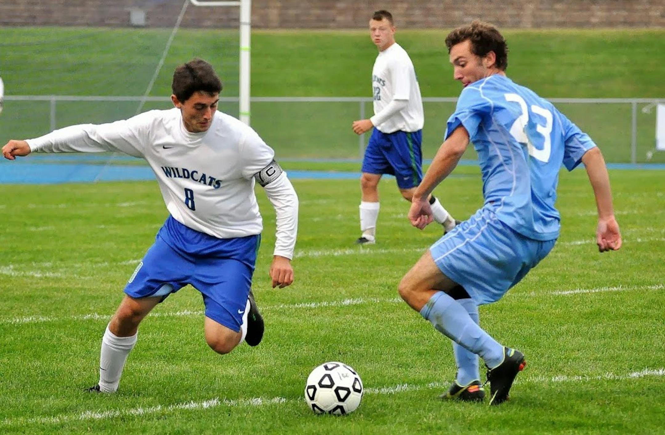 Eagan's Ed Olson (8) battles a defender from Bloomington Jefferson as Jack Kelm (22) looks on.
