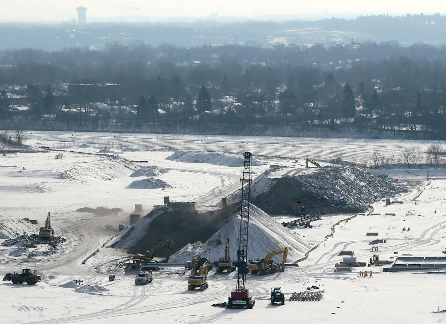 The massive Ford site in Highland Park, which occupies 144 acres including the Highland Little League Park, is now clear of buildings with pollution cleanup continuing and the remaining concrete foundations and slabs should be gone by mid-summer. The property is expected to go on the market by the end of 2015. Here, heavy machinery and a large concrete debris and class five gravel pile are visible from the 24th floor of the nearby 740 River Drive luxury apartment building Wednesday, Jan. 14, 201