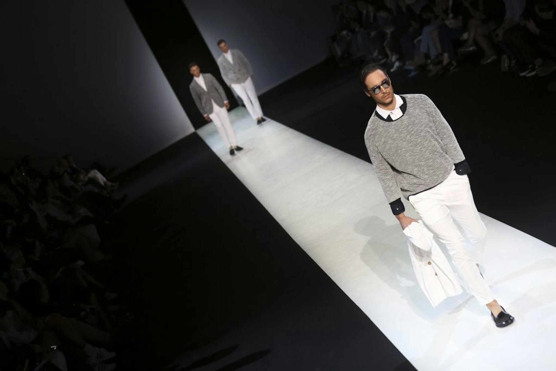 Models wear creations for Giorgio Armani men's Spring-Summer 2014 collection, part of the Milan Fashion Week, unveiled in Milan, Italy, Tuesday, June 25, 2013.