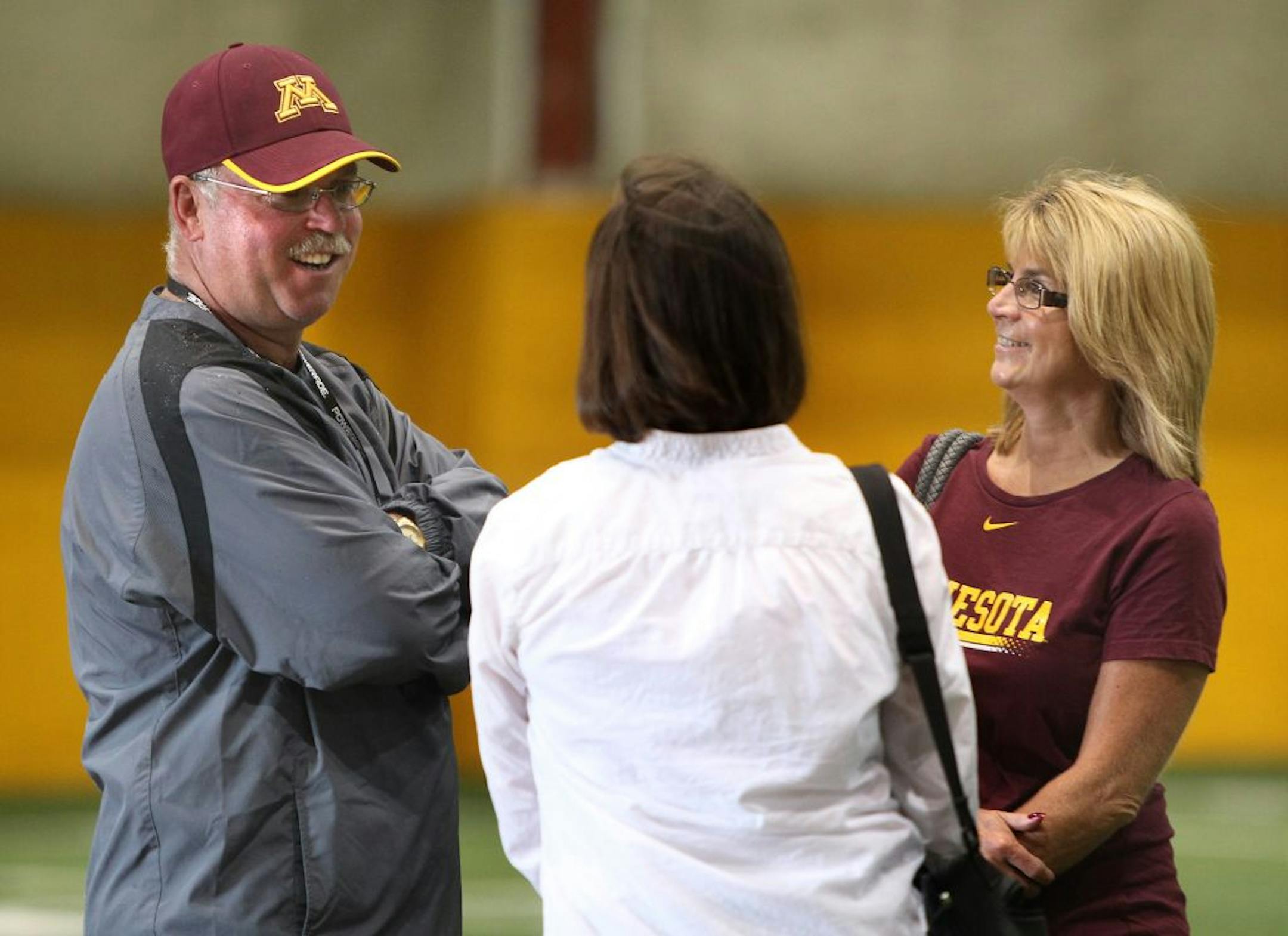Minnesota Gophers head coach Jerry Kill briefly chatted with his wife Rebecca Kill as the spoke with visitors.