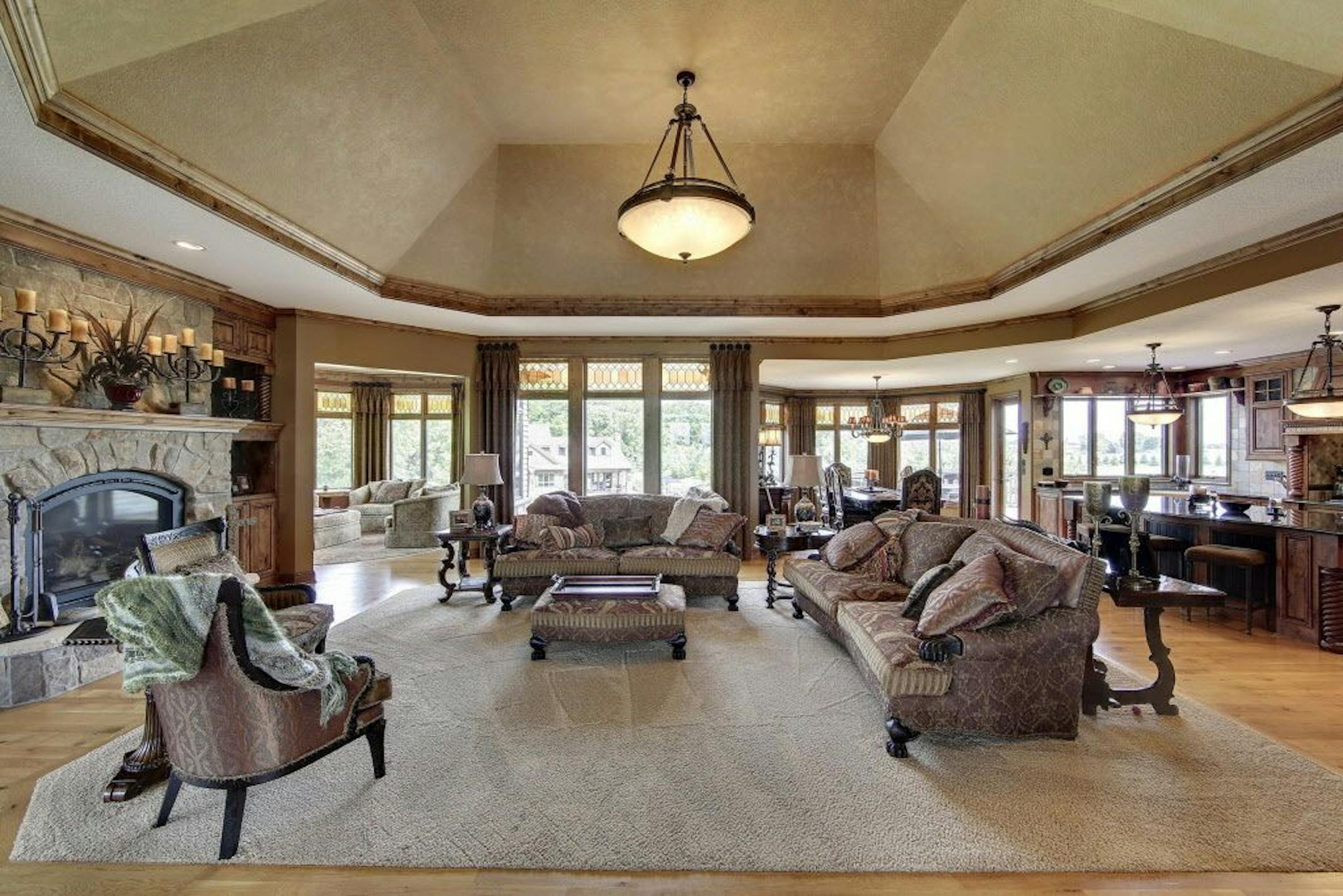 The great room features a stone fireplace.