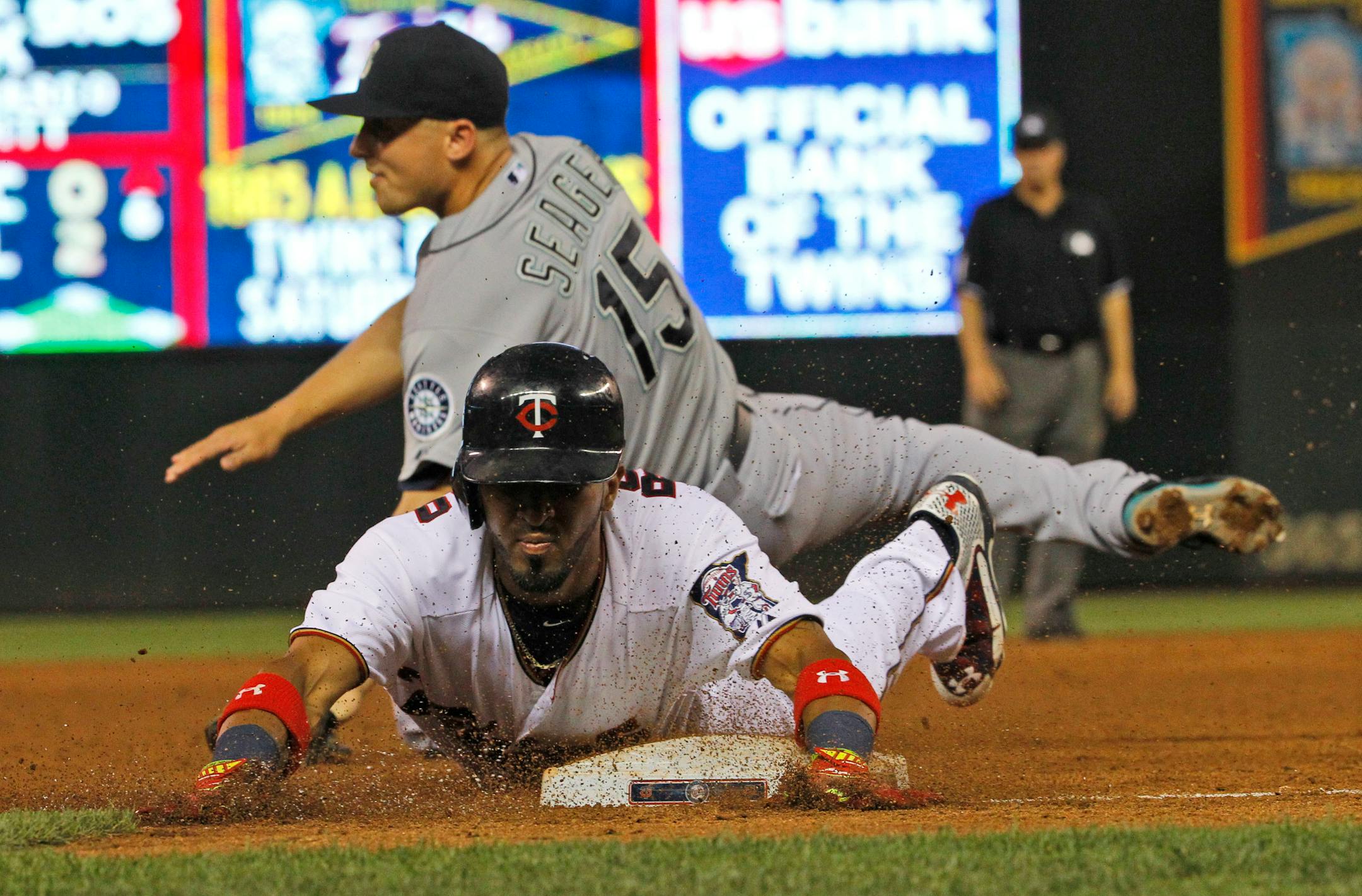 The Twins' Eddie Rosario slid safely into third on a triple in front of Mariners third baseman Kyle Seager during the fifth inning of Minnesota's 9-5 victory Thursday. Rosario missed hitting for the cycle by a single, after being robbed on a line drive in the ninth.