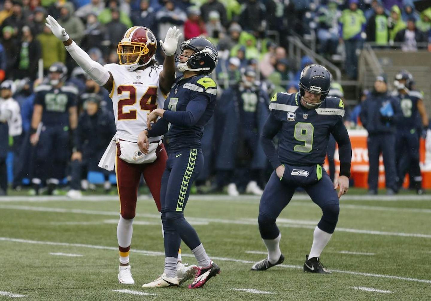 Washington Redskins cornerback Josh Norman (24) and Seattle Seahawks holder Jon Ryan (9) react after Seahawks kicker Blair Walsh, center, missed a field goal-attempt in the first half of an NFL football game, Sunday, Nov. 5, 2017, in Seattle.