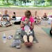 With her Shih Tzu Hannah,6, in her lap Diane Turnbull, middle, does the namaste pose to end the doga-- a yoga class that you can take your dog to-- ho
