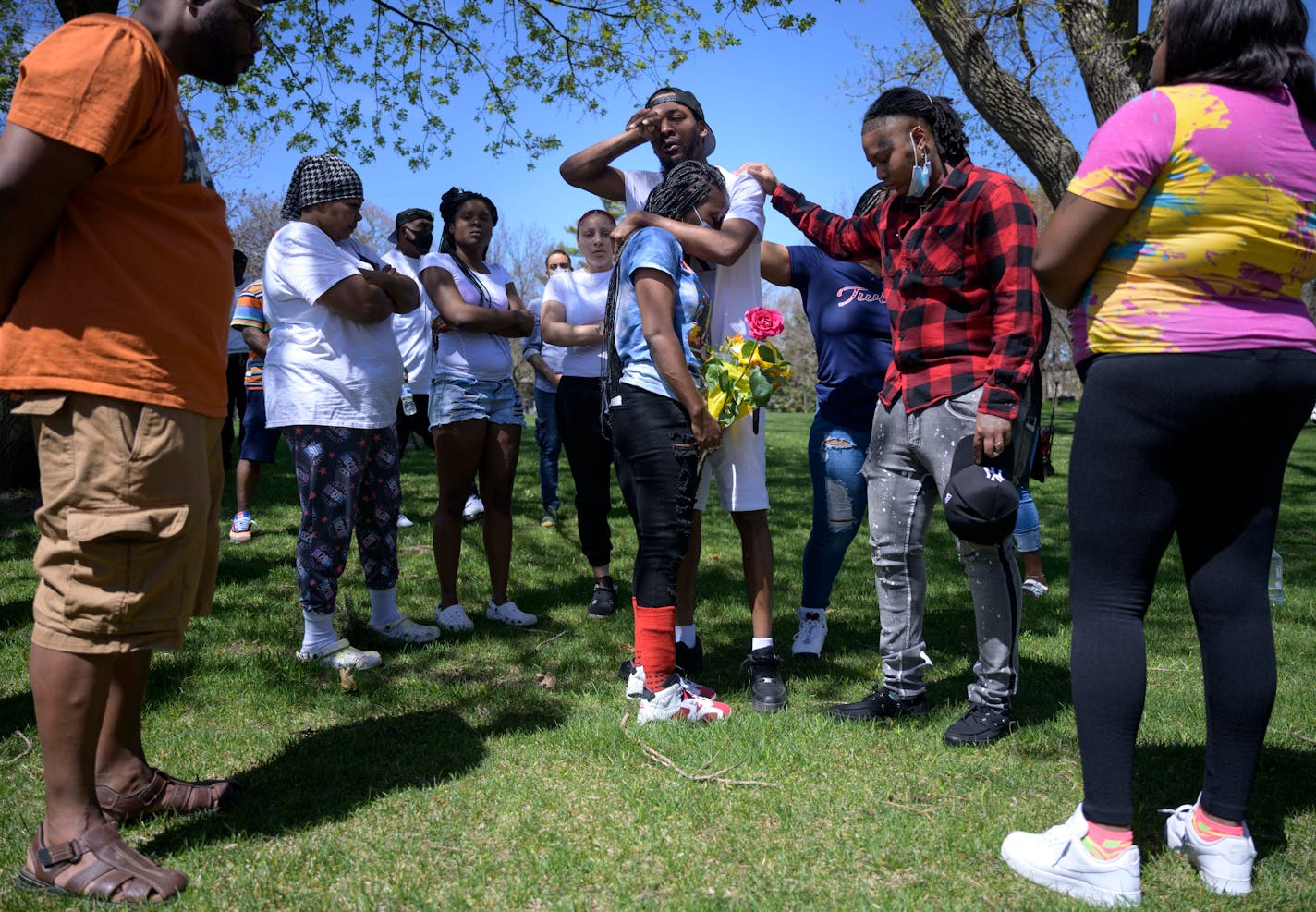 Surrounded by friends and family, Ladavionne Garrett shared an emotional embrace with Dorice Jackson at a prayer vigil for their 10-year old son, who was critically injured in a shooting Friday afternoon in North Minneapolis. The child is in critical condition after going through emergency surgery.