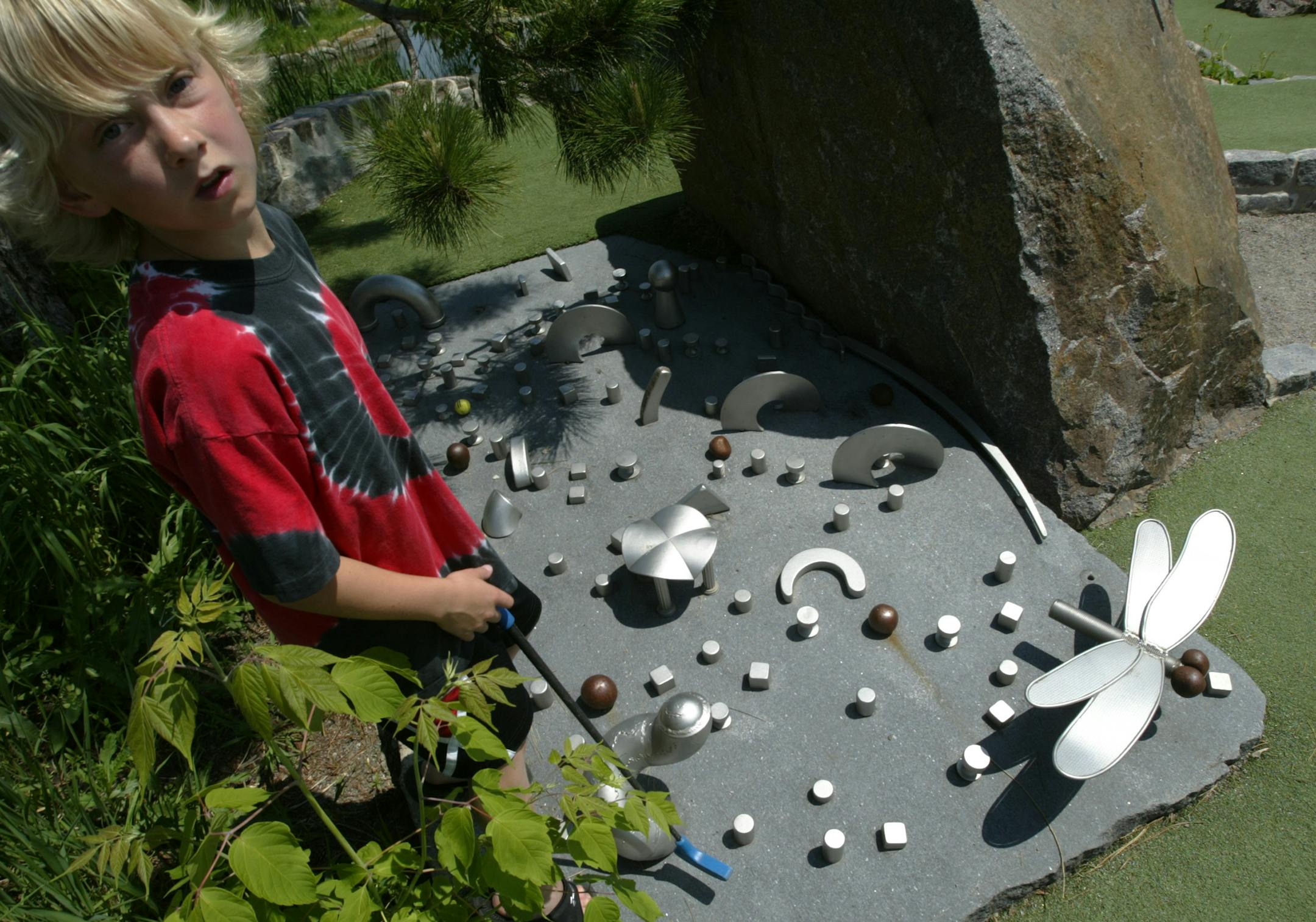 Brendan Dreyer from Minnetrista, MN waits on hole 12 called Pachinko. Bruce Stillman owns Bigstone mini golf and Sculpture gardens is the newest miniature-golf course in Minnetrista.