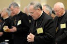 FILE - In this Monday, Nov. 10, 2008 file photo, Bishop Michael J. Hoeppner of Crookston, Minn. prays during a semi-annual meeting of the United State