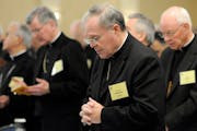 FILE - In this Monday, Nov. 10, 2008 file photo, Bishop Michael J. Hoeppner of Crookston, Minn. prays during a semi-annual meeting of the United State