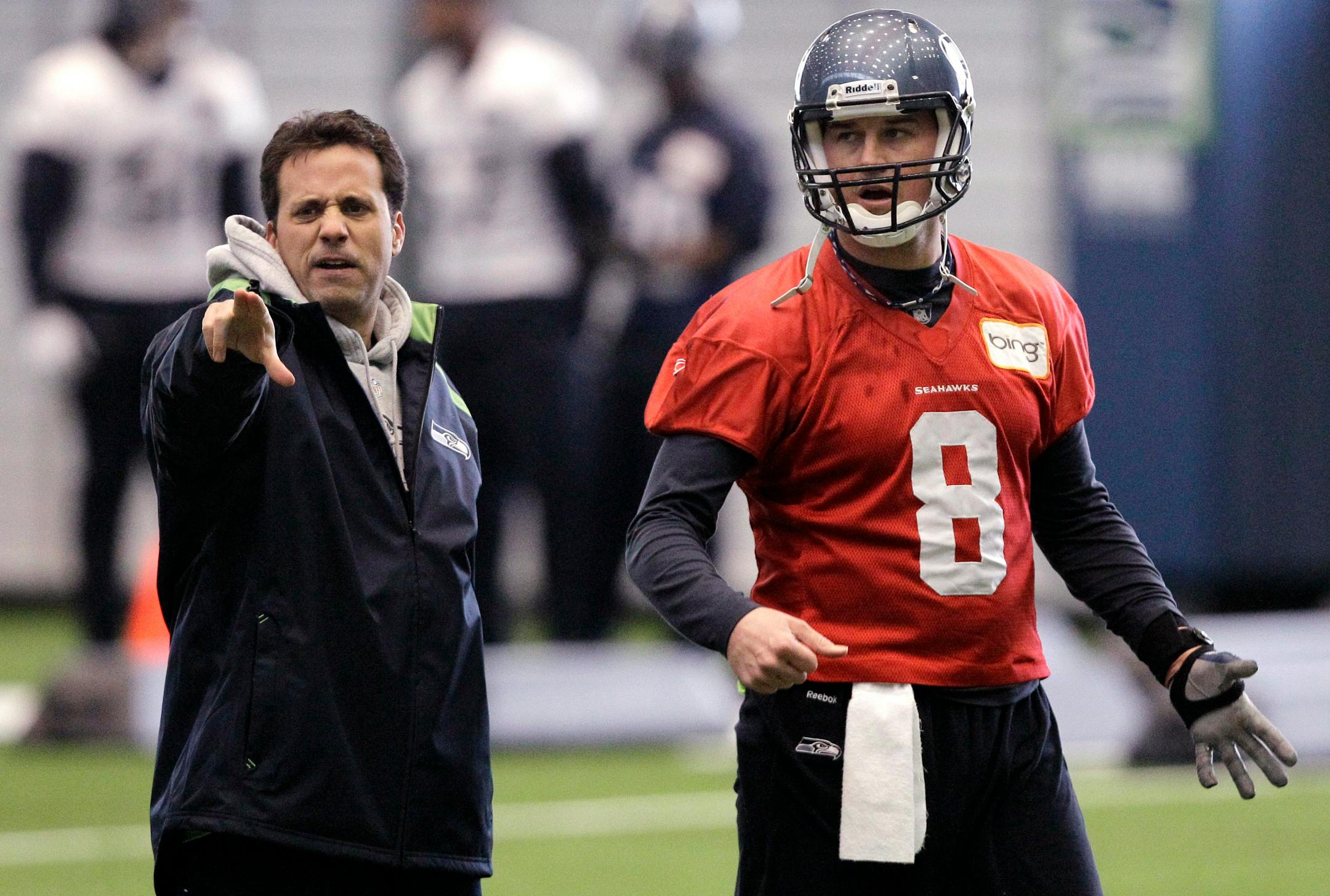 In this photo taken Tuesday, Jan. 4, 2011, Seattle Seahawks quarterback coach Jedd Fisch, left, works with quarterback Matt Hasselbeck during NFL football practice in Renton, Wash. Fisch has been hired as offensive coordinator and quarterbacks coach for the Miami Hurricanes on Thursday, Jan. 13, 2011. He will remain with the Seahawks for the remainder of their playoff run. At Miami, he'll replace Mark Whipple, who wasn't retained by new coach Al Golden. (AP Photo/Elaine Thompson)