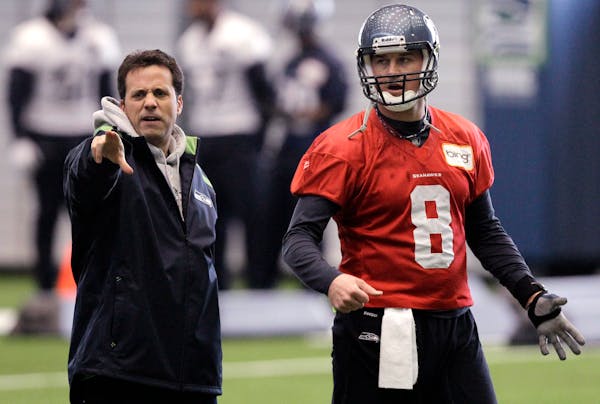 In this photo taken Tuesday, Jan. 4, 2011, Seattle Seahawks quarterback coach Jedd Fisch, left, works with quarterback Matt Hasselbeck during NFL foot