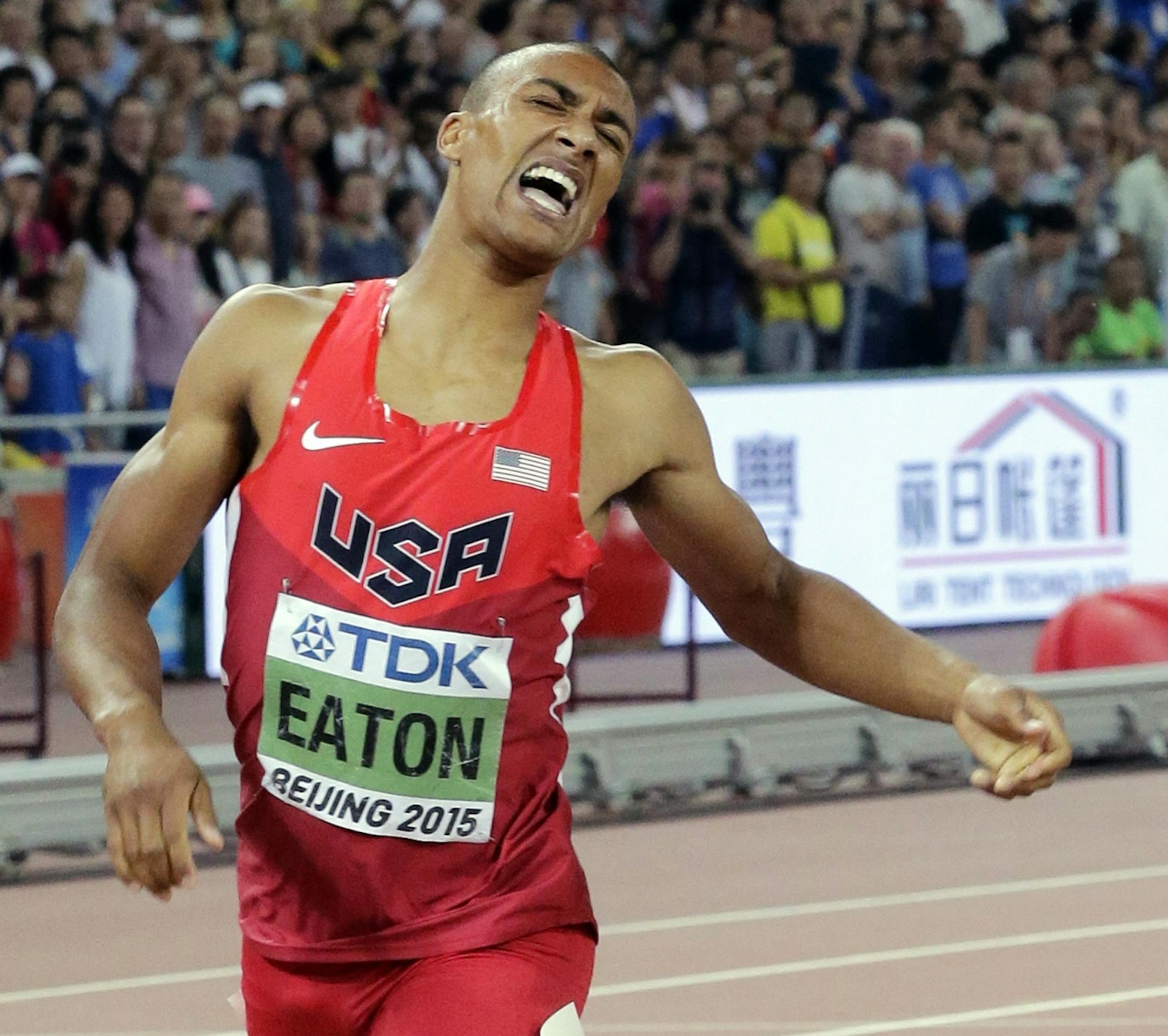 United States' Ashton Eaton crosses the line to win the gold medal in the decathlon at the World Athletics Championships at the Bird's Nest stadium in Beijing, Saturday, Aug. 29, 2015. (AP Photo/Andy Wong)