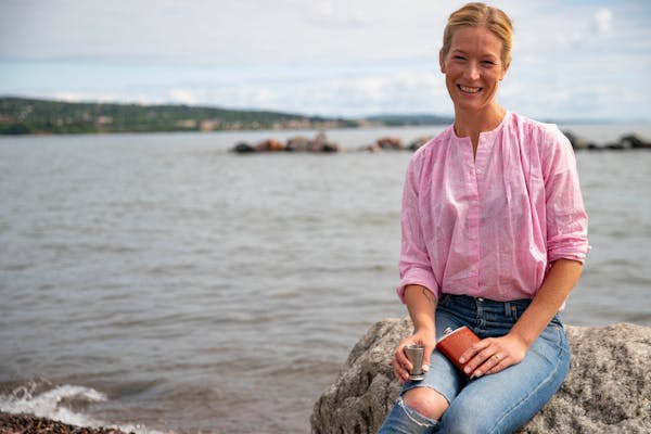 Emily Vikre posed with her travel flask and collapsible cup on the shore of Lake Superior in Duluth: "You don't need perfect bartending tools to make 