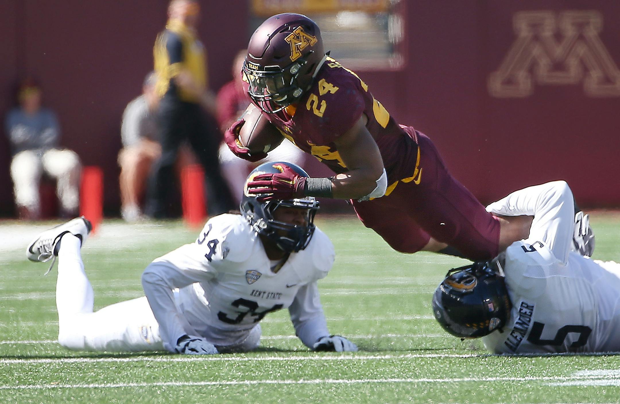 Minnesota's running back Rodney Smith carried the ball despite defensive pressure from Kent State linebacker James Alexander in the third quarter as the Gophers took on Kent State at TCF Bank Stadium, Saturday, September 19, 2015 in Minneapolis, MN.