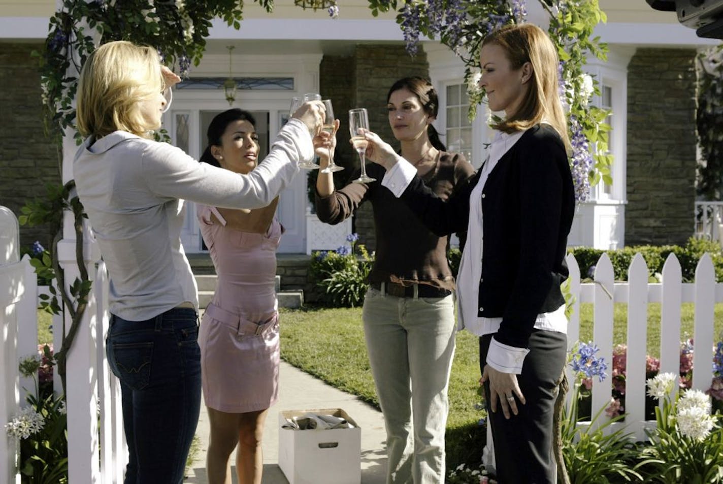 FILE - This undated photo from ABC shows, from left, Felicity Huffman, Eva Longoria, Teri Hatcher and Marcia Cross toasting one another in a scene from ABC's "Desperate Housewives." According to a person familiar with ABC's plans for the drama, next season will be its last. The person spoke on condition of anonymity because the network and producers hadn't authorized public comment. ABC, which is scheduled to discuss its fall schedule at a news conference Sunday, Aug. 7, 2011 declined comment.