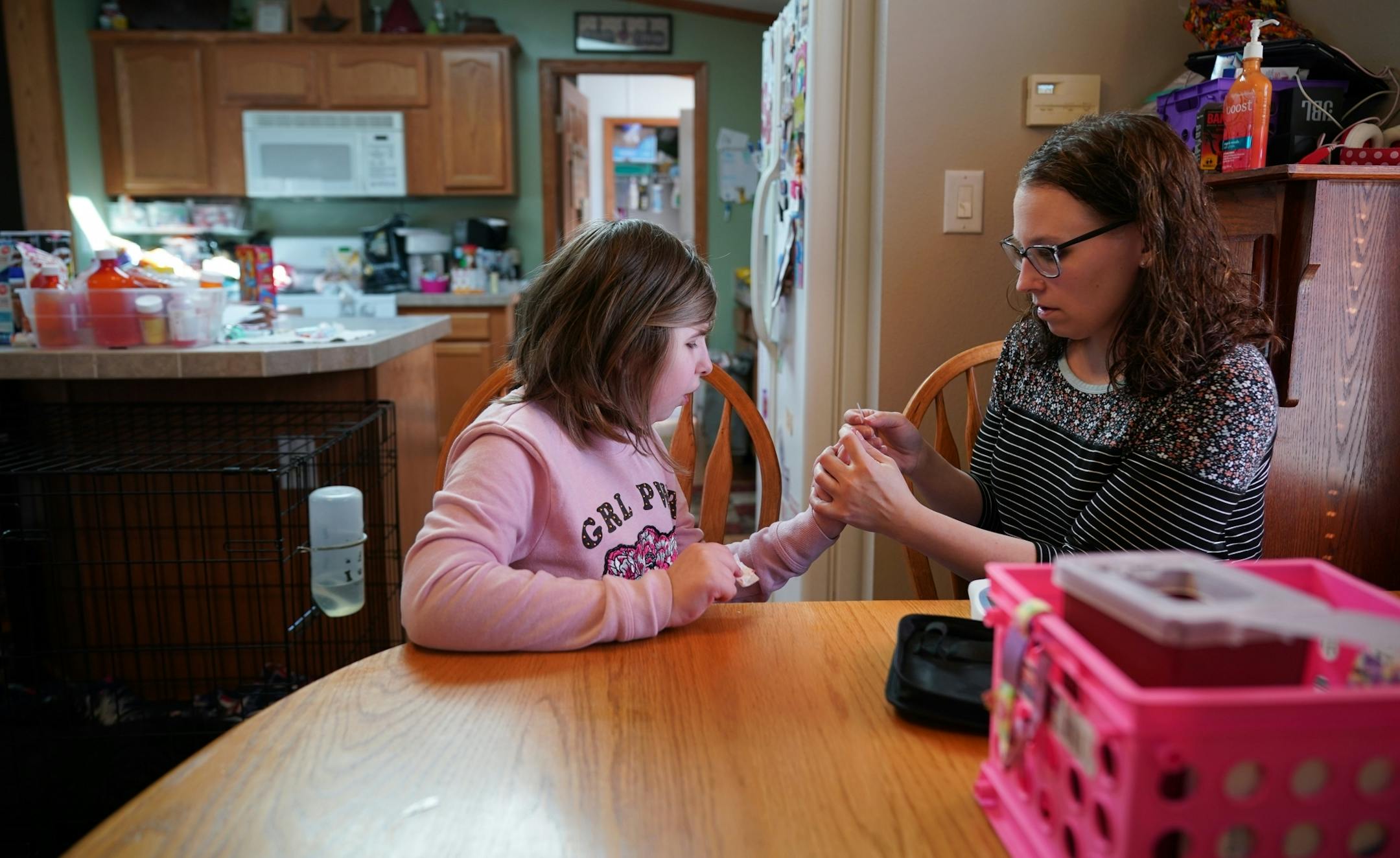 Linsey Rippy tested Madi's blood with a small stick and a blood test. She then called the results into her doctor at the Mayo Clinic. The INR test measures the thinness of Madi's blood, necessary after her heart transplant. Madi is 12.