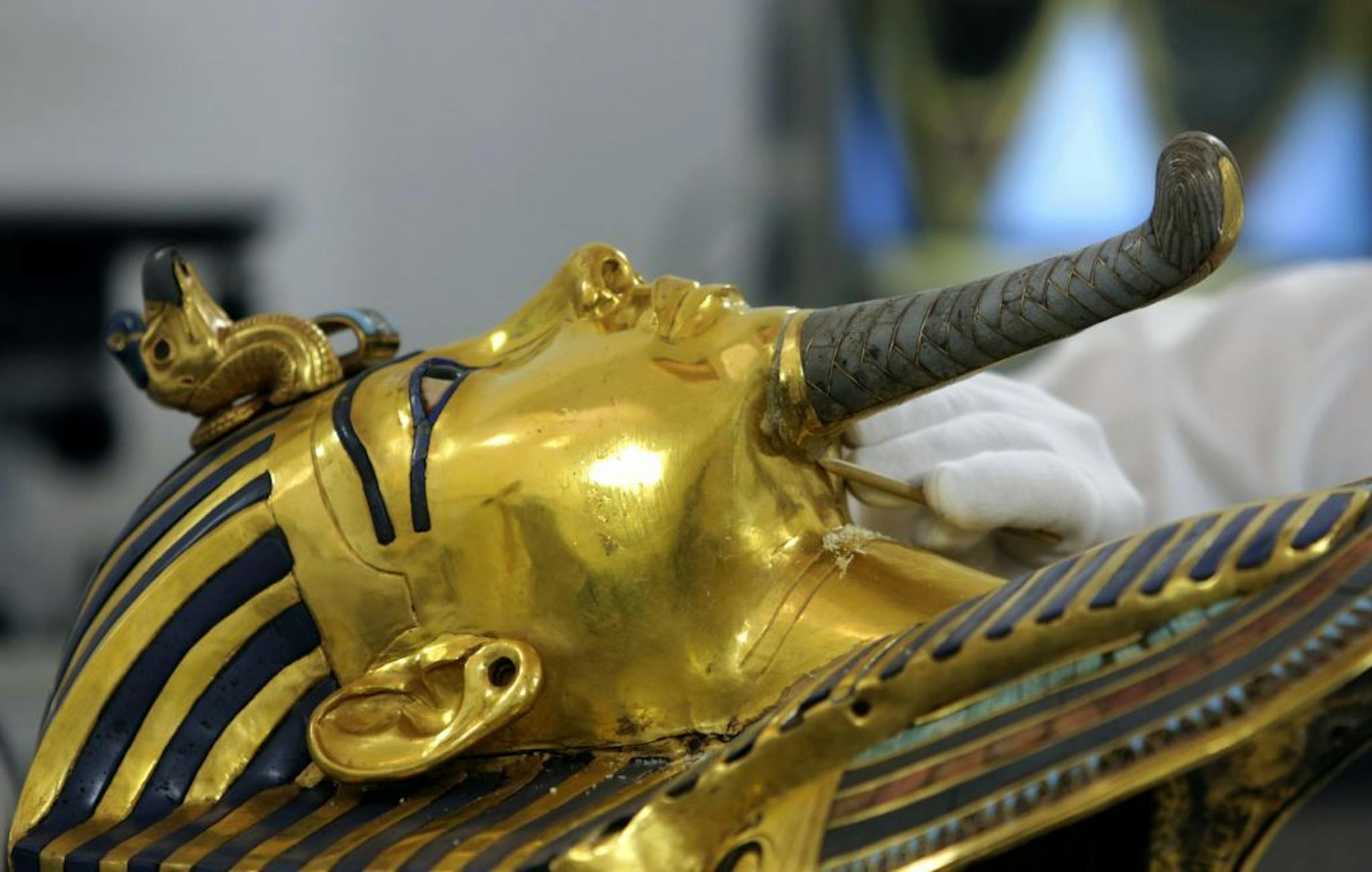 German restorer Christian Eckmann examines the beard of the famed golden mask of King Tutankhamun as an Egyptian-German team begins restoration work over a year after the beard was accidentally broken off and hastily glued back with epoxy, at the Egyptian Museum in Cairo, Egypt, Tuesday, Oct. 20, 2015. The 3,300-year-old burial pharaonic mask was discovered in Tutankhamun's tomb along with other artifacts by British archeologists in 1922, sparking worldwide interest in archaeology and ancient Eg