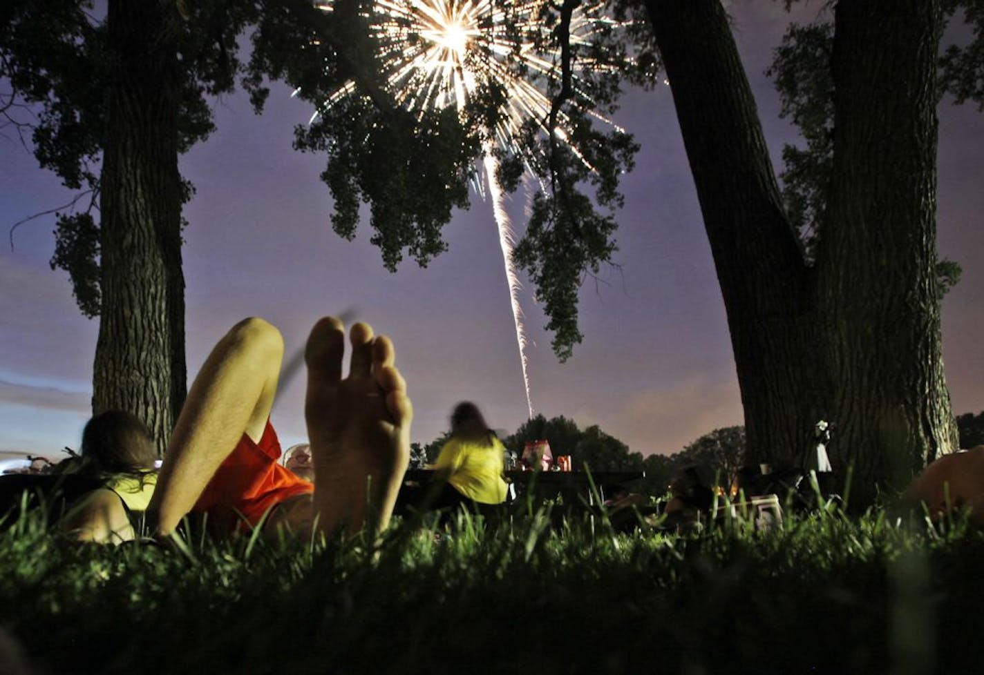 DAVID JOLES � djoles@startribune.com Minneapolis, MN - July 4, 2010- The soft grass of Powderhorn Park was a perfect spot to watch Fourth of July fireworks in the park.