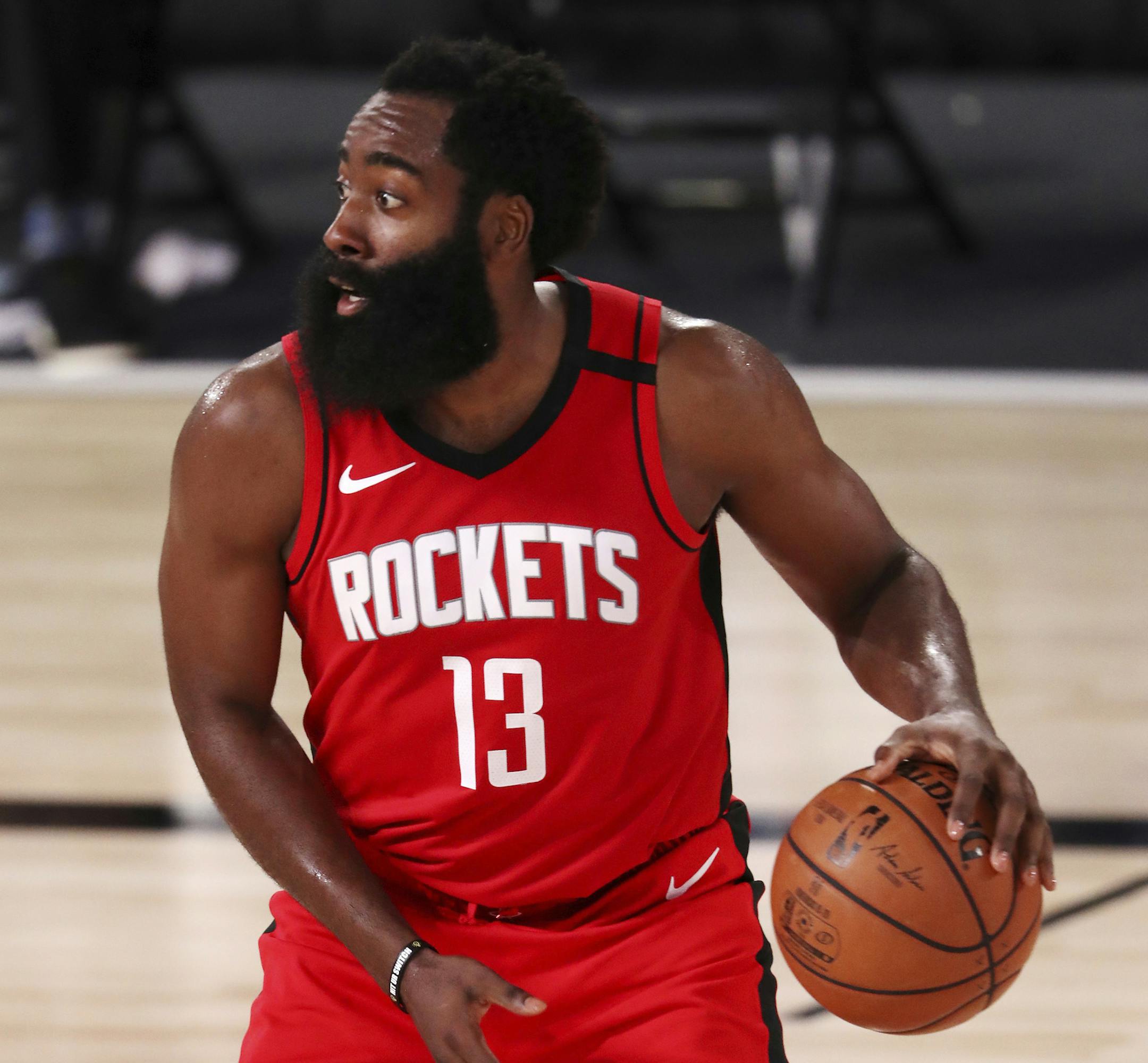 Houston Rockets James Harden (13) dribbles the ball against the Dallas Mavericks during the second half of an NBA basketball game Friday, July 31, 2020, in Lake Buena Vista, Fla. (Mike Ehrmann/Pool Photo via AP)