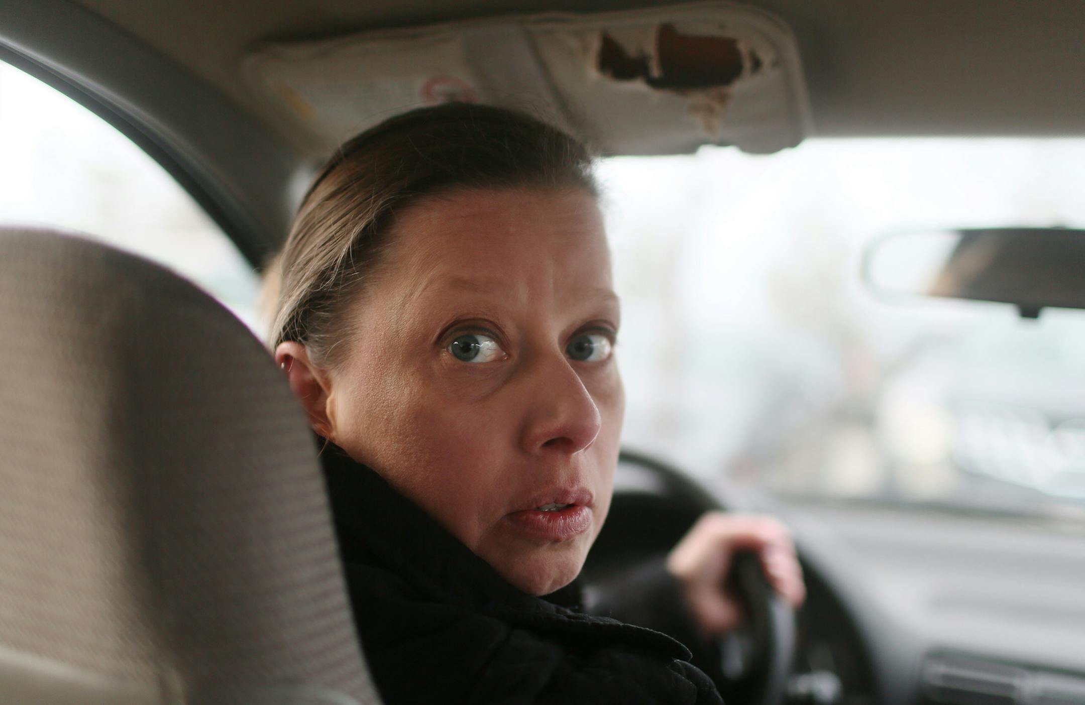 Attorney Joely Macheel, 44, is seen outside a NE Minneapolis coffeeshop in her 1999 Saturn, Saturday, Jan. 31, 2015, in Minneapolis, MN. Micheel does mostly temping and typically makes a little more than $20 an hour, despite holding a law degree and an MBA and is nearly $300,000 in debt.](DAVID JOLES/STARTRIBUNE)djoles@startribune.com Joely Macheel, 44, is a licensed attorney who lives in northeast Minneapolis. She says she is deep in debt after getting a law degree and an MBA, but she canȁ