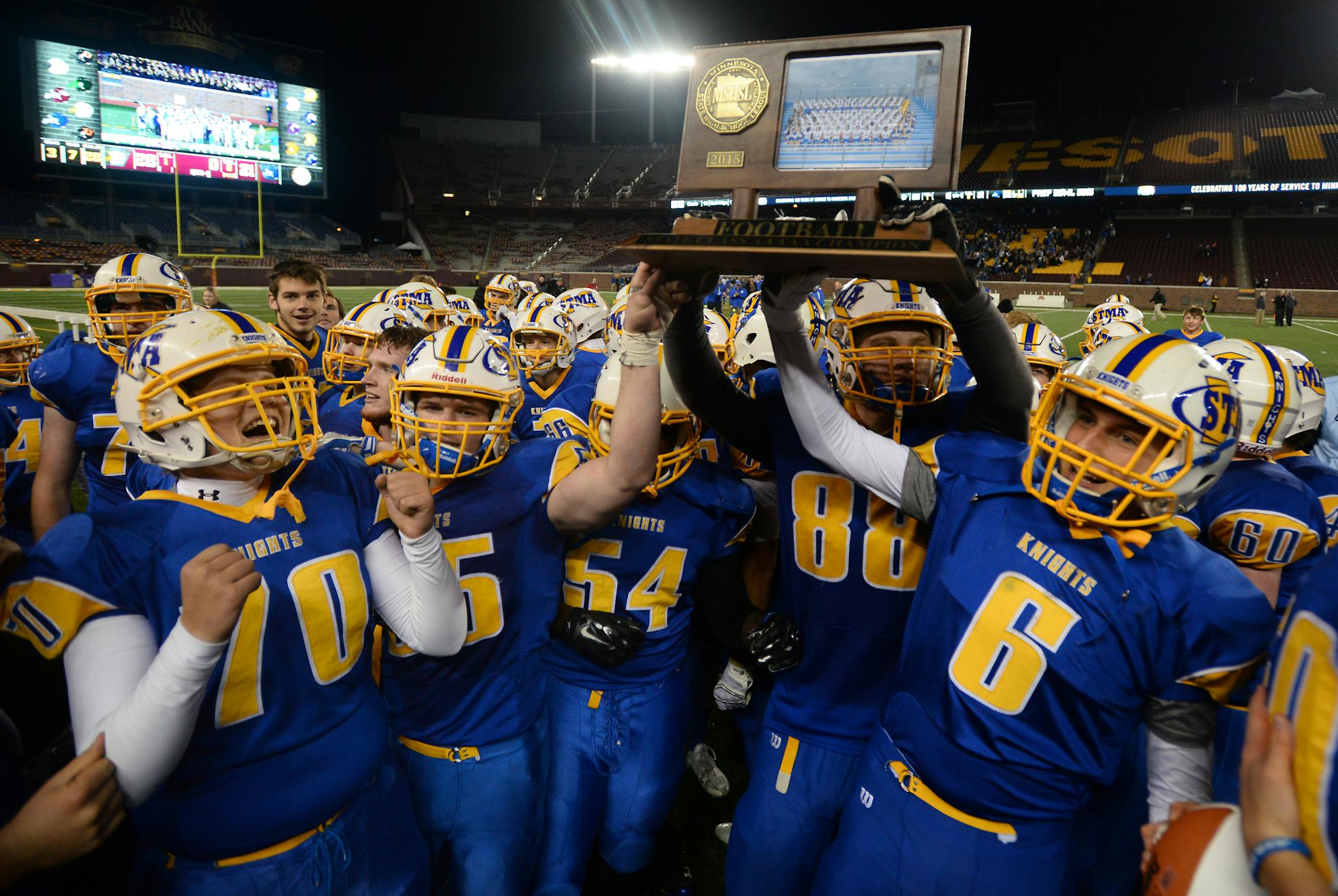 St. Michael-Albertville players celebrated with their 5A championship trophy after defeating St. Thomas Academy 28-21 Saturday night. ] (AARON LAVINSKY/STAR TRIBUNE) aaron.lavinsky@startribune.com St. Thomas Academy played St. Michael-Albertville in the Class 5A championship game on Saturday, Nov. 14, 2015 at TCF Bank Stadium.