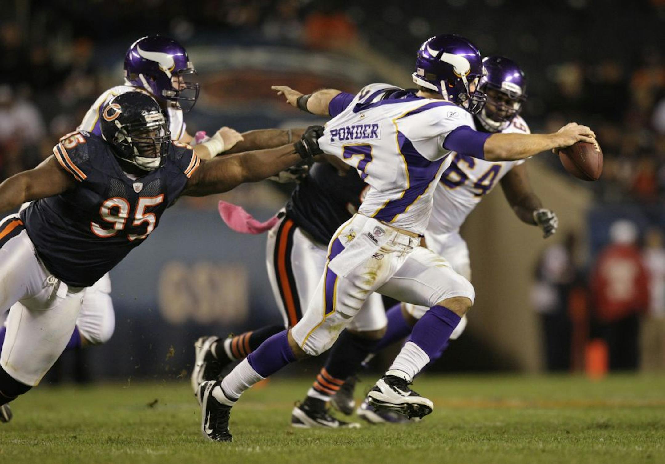 Vikings quarterback Christian Ponder scrambles away from Bears Anthony Adams late in the 4th quarter. Ponder replaced Donovan McNabb who had a terrible game.